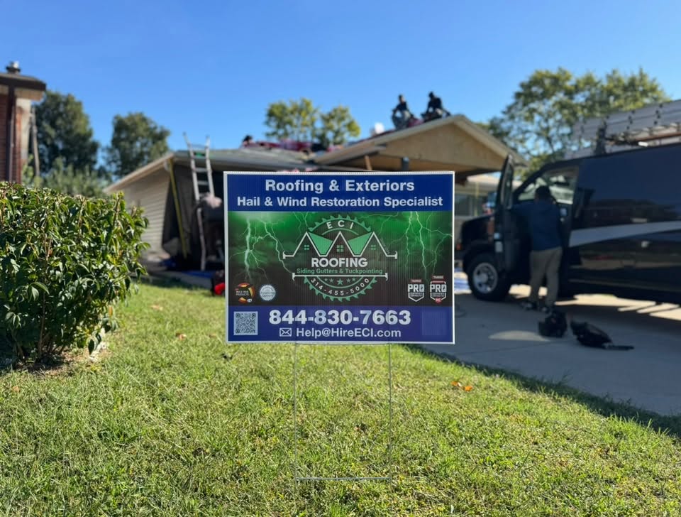 ECI yard sign on a sunny day with crew on the roof