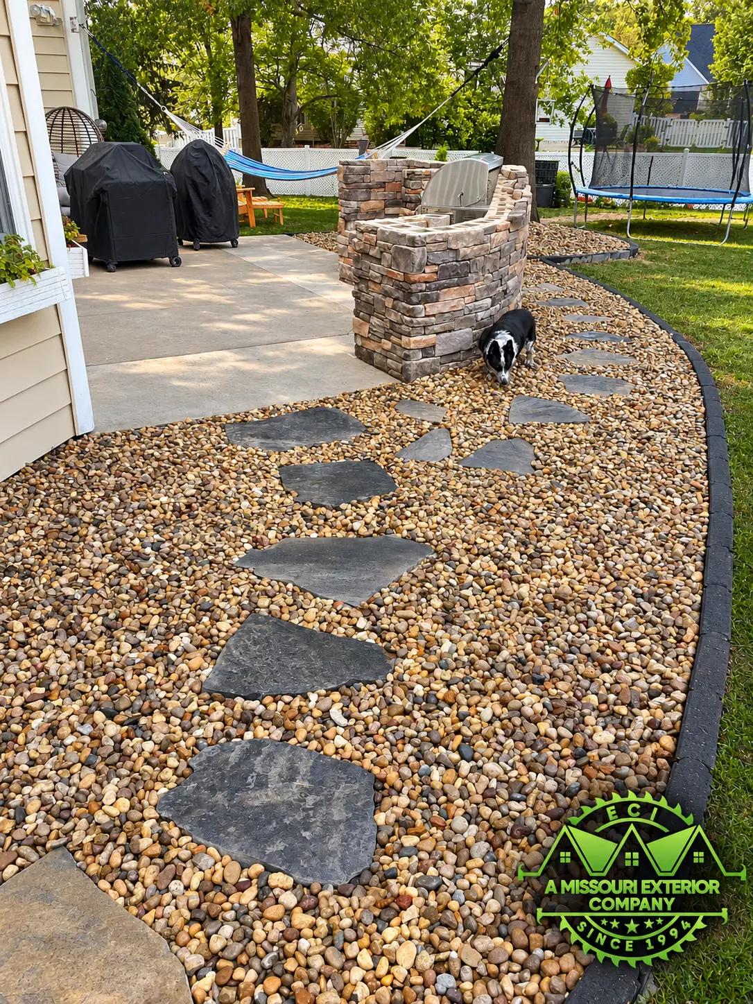 Flagstone stepping path and gravel beside the outdoor kitchen