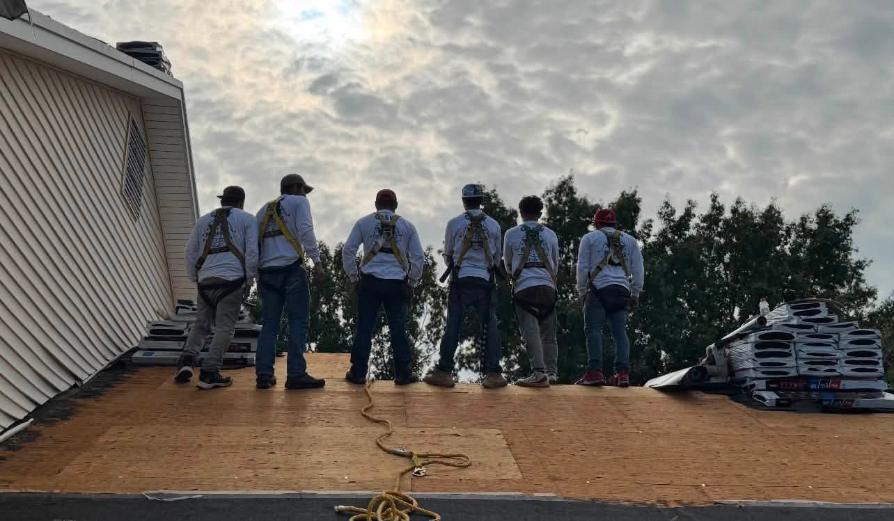 ECI roofing crew members in safety harnesses on a Missouri roof deck