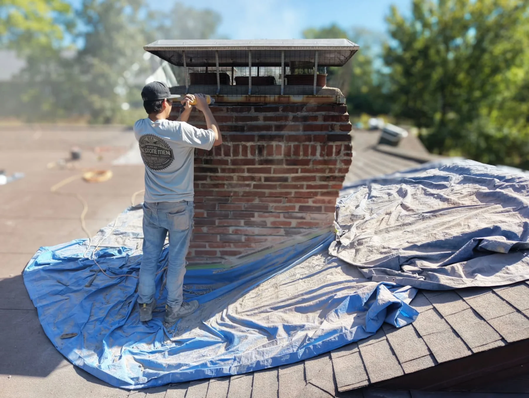 Mason working on a brick chimney