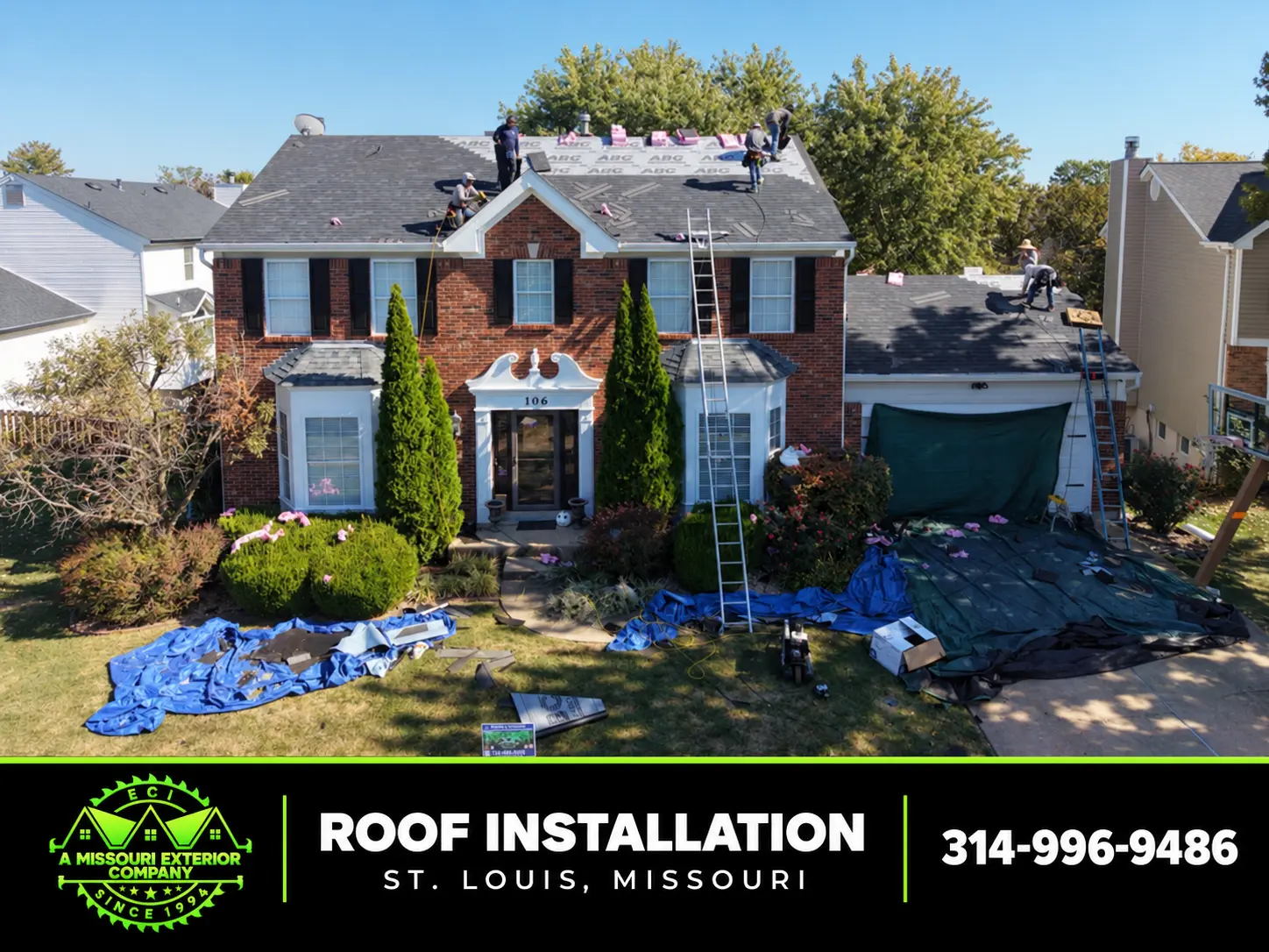 ECI crew installing a new roof on a brick two-story home