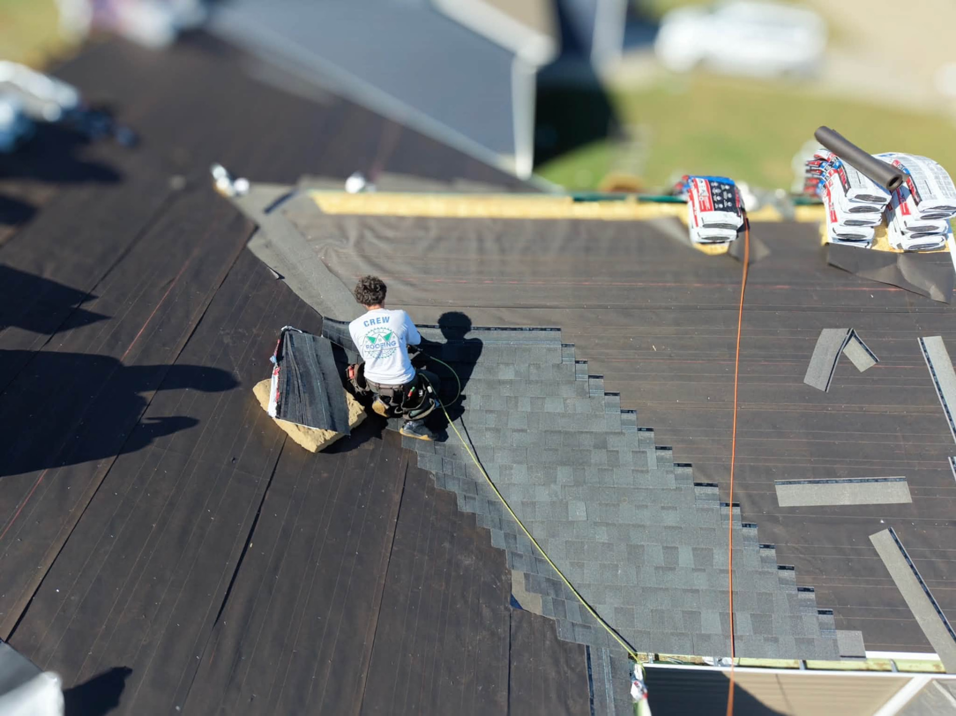 ECI crew laying shingles, close aerial view