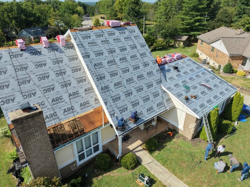 ECI crew installing underlayment on a steep slope