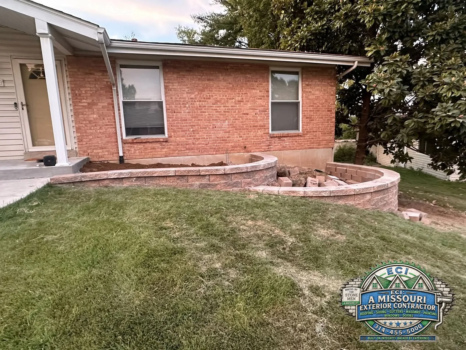 Masonry retaining wall beside a property
