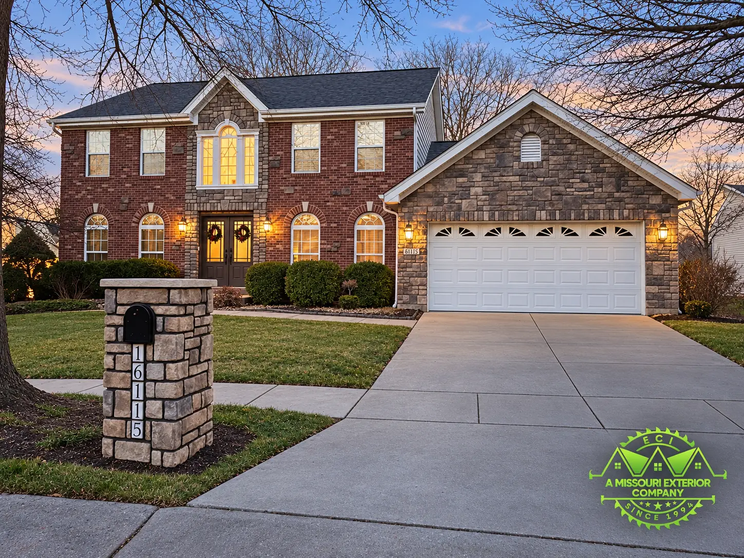 Completed ECI brick home with stone accents at the entry and garage and a matching stone mailbox