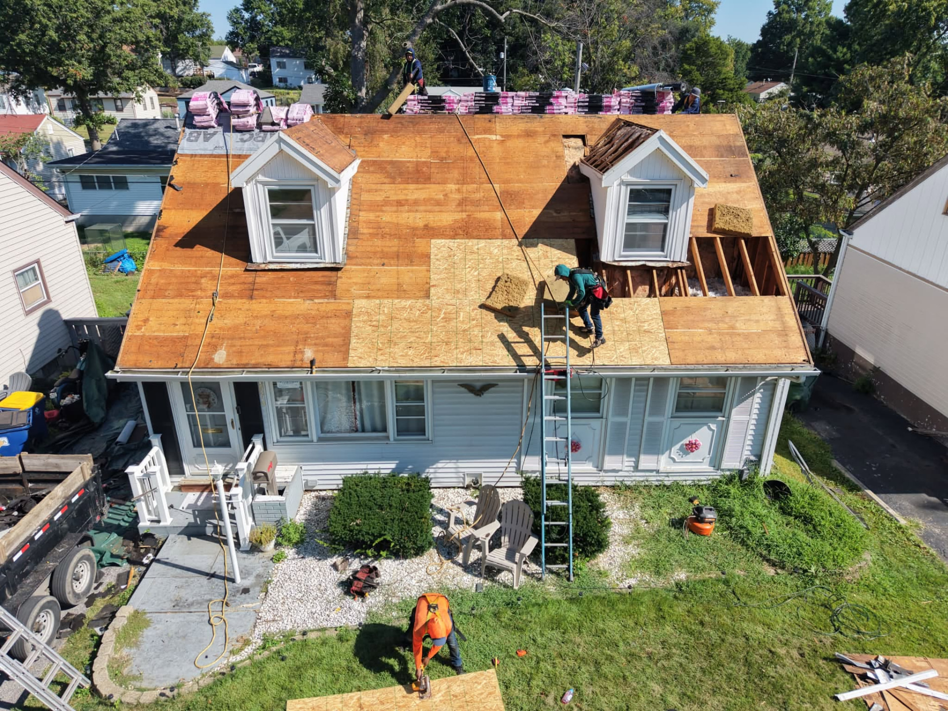 Crew re-decking a cape cod