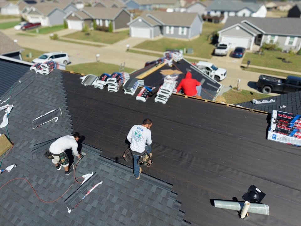 ECI crew installing underlayment and shingles, aerial