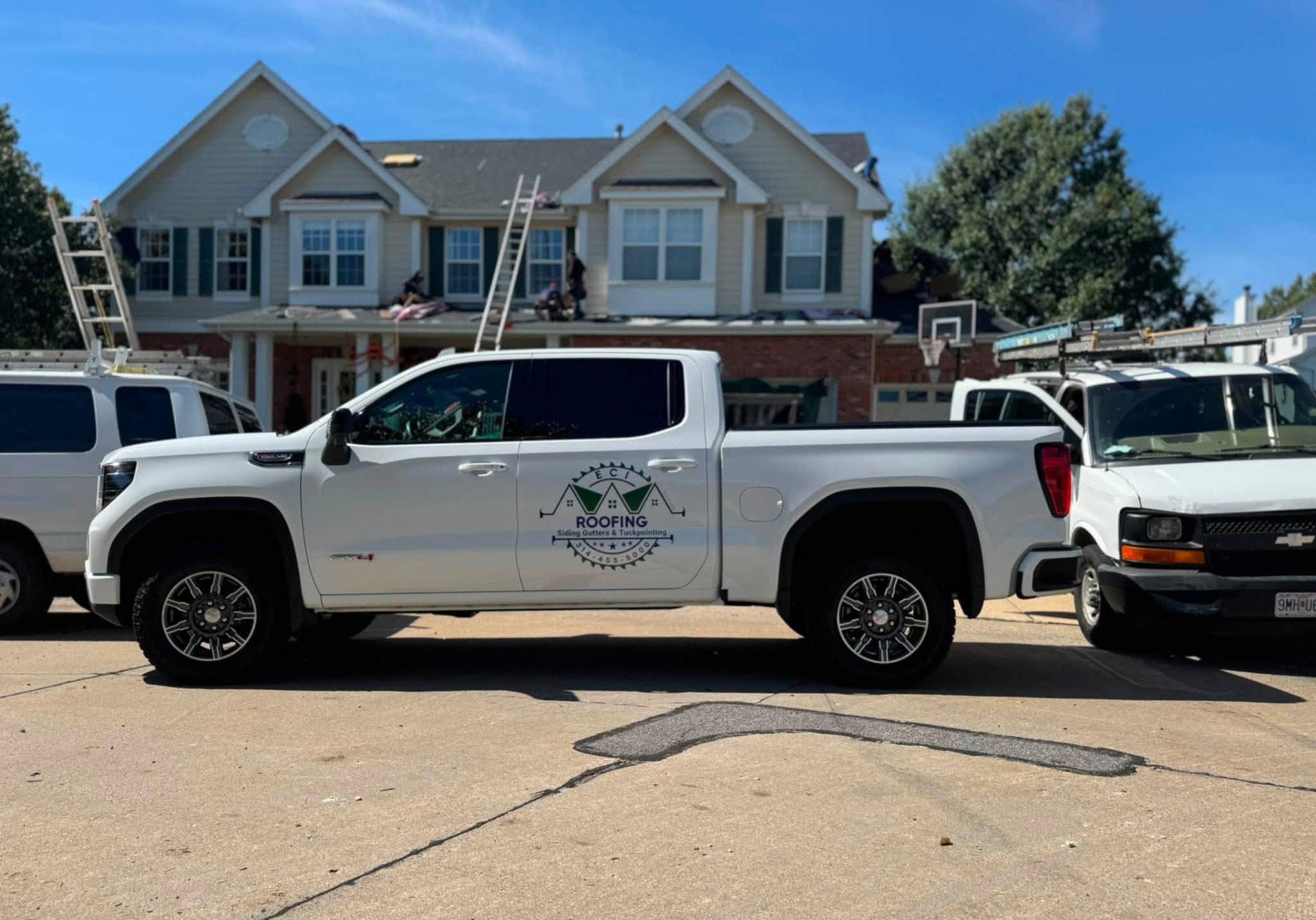 ECI truck at a two-story home while the crew re-roofs