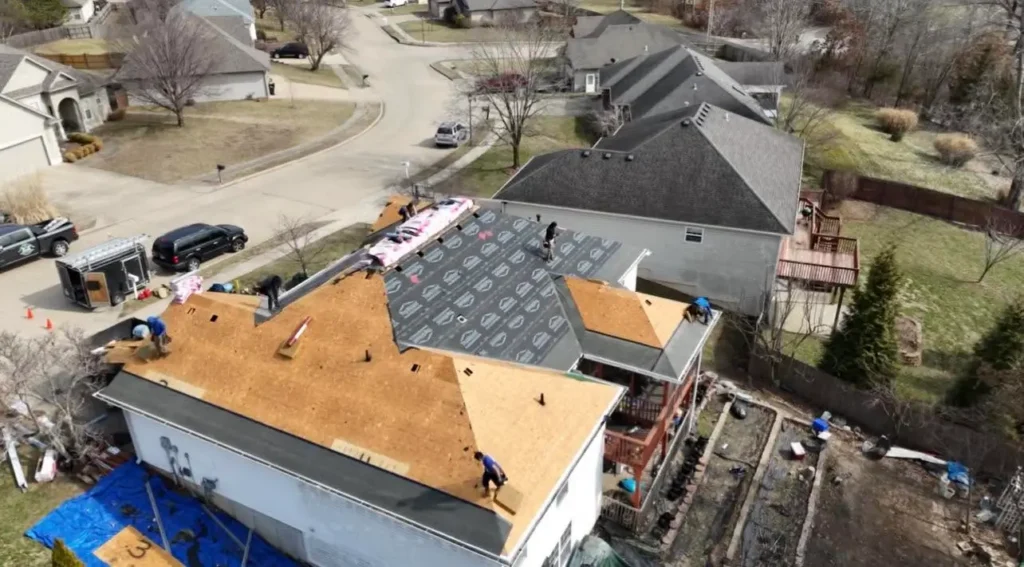roofing crew on top of the roof doing a roofing project